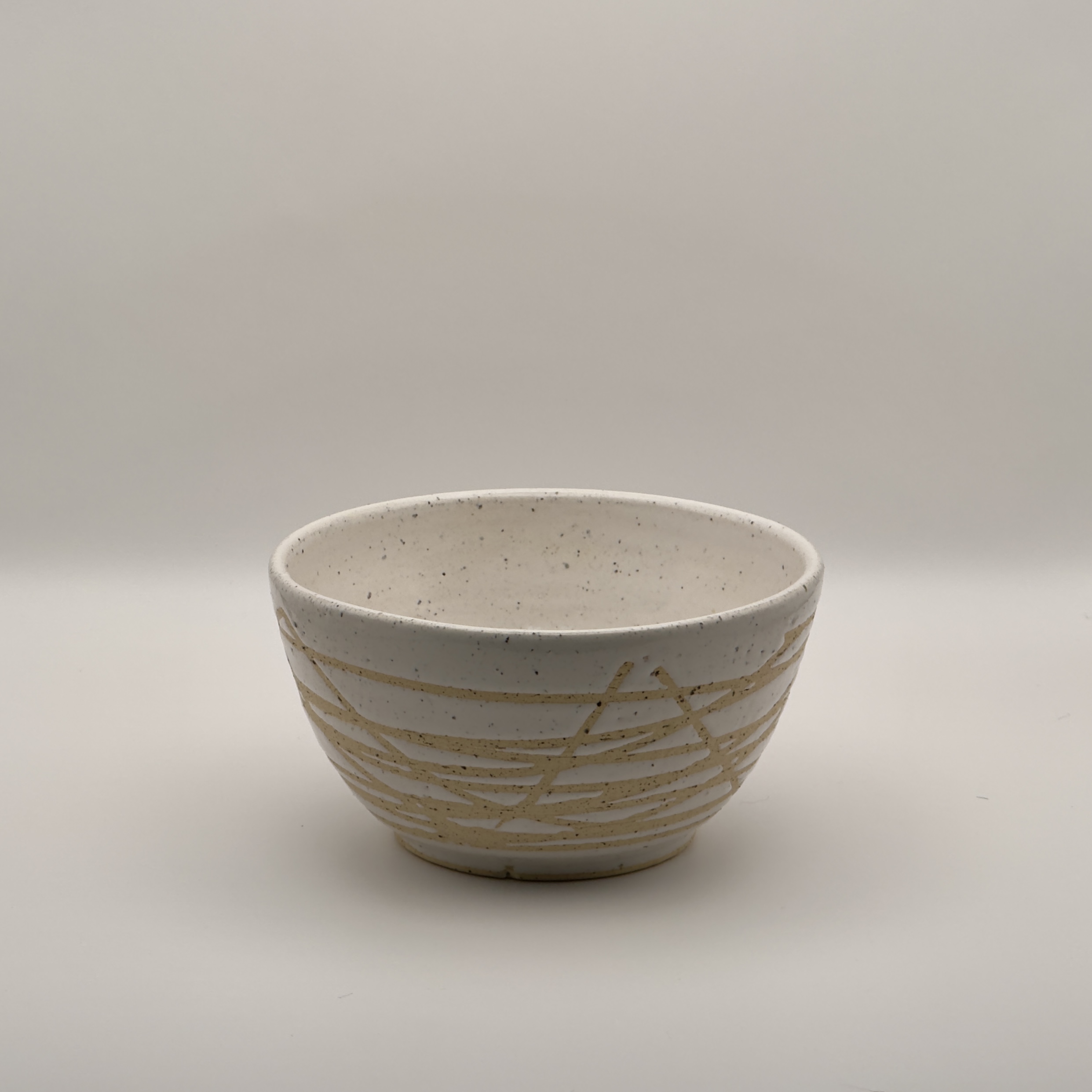 White bowl with a tan crackle swirl pattern
