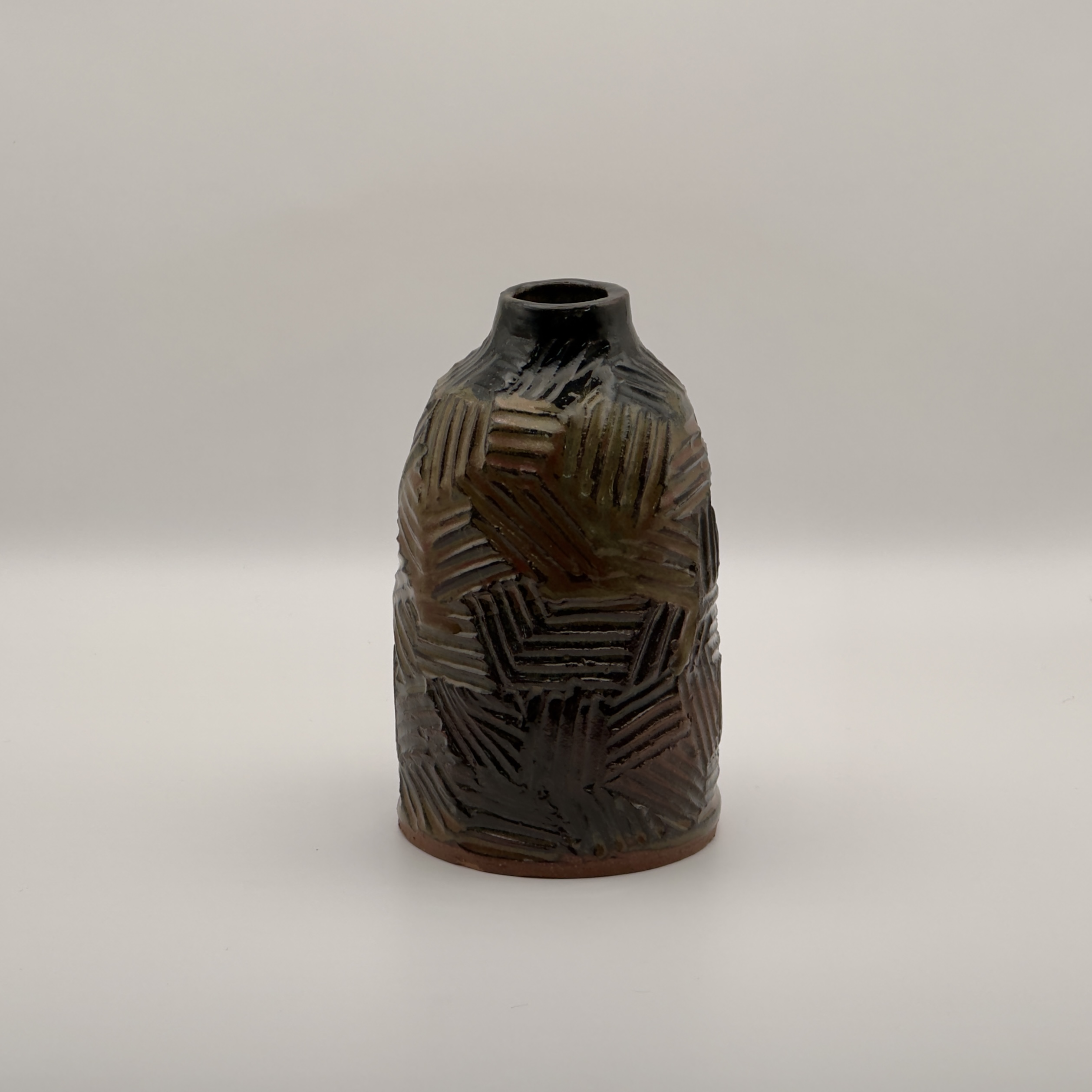 Dark blamp with a carved cross-hatch pattern