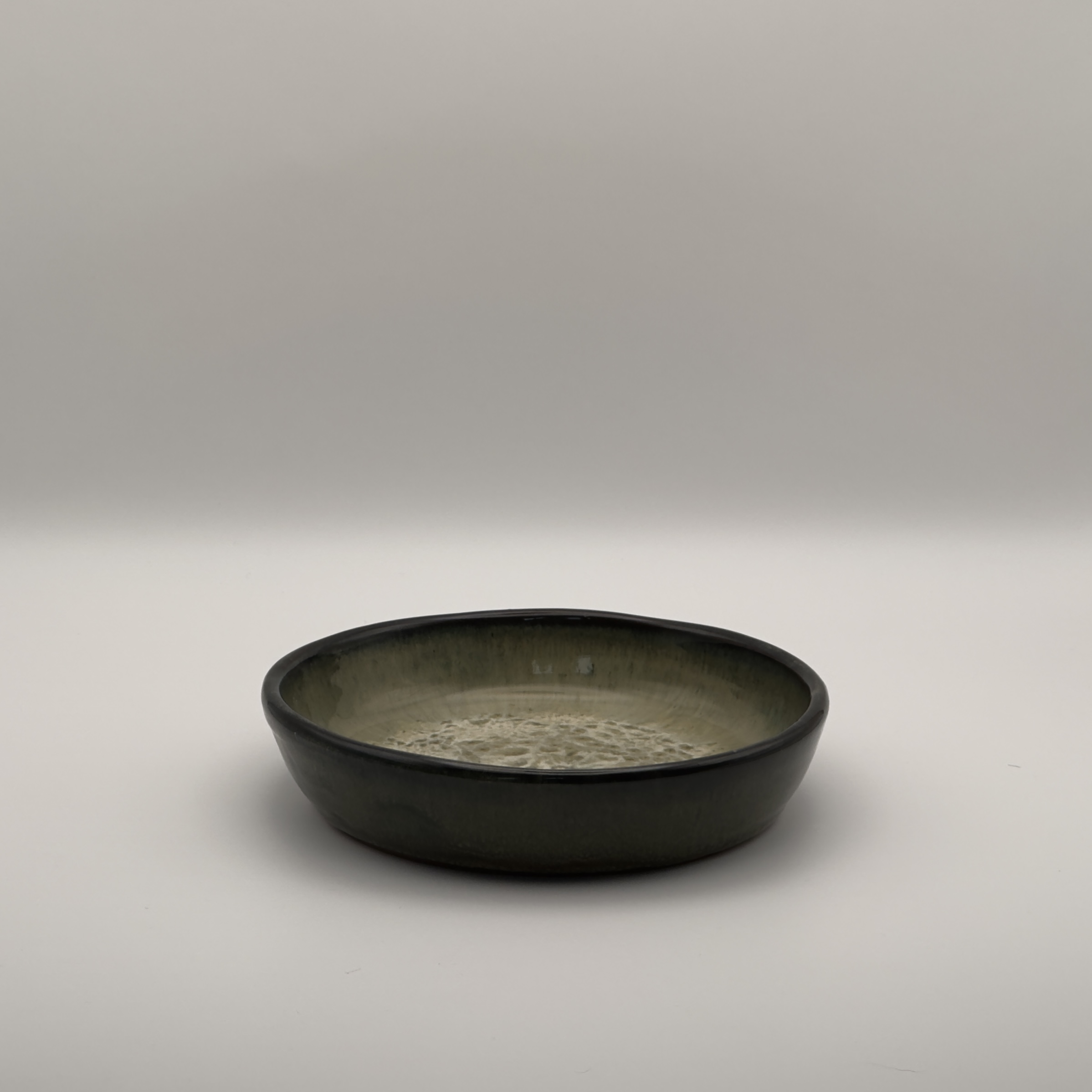 Dark green shallow round dish