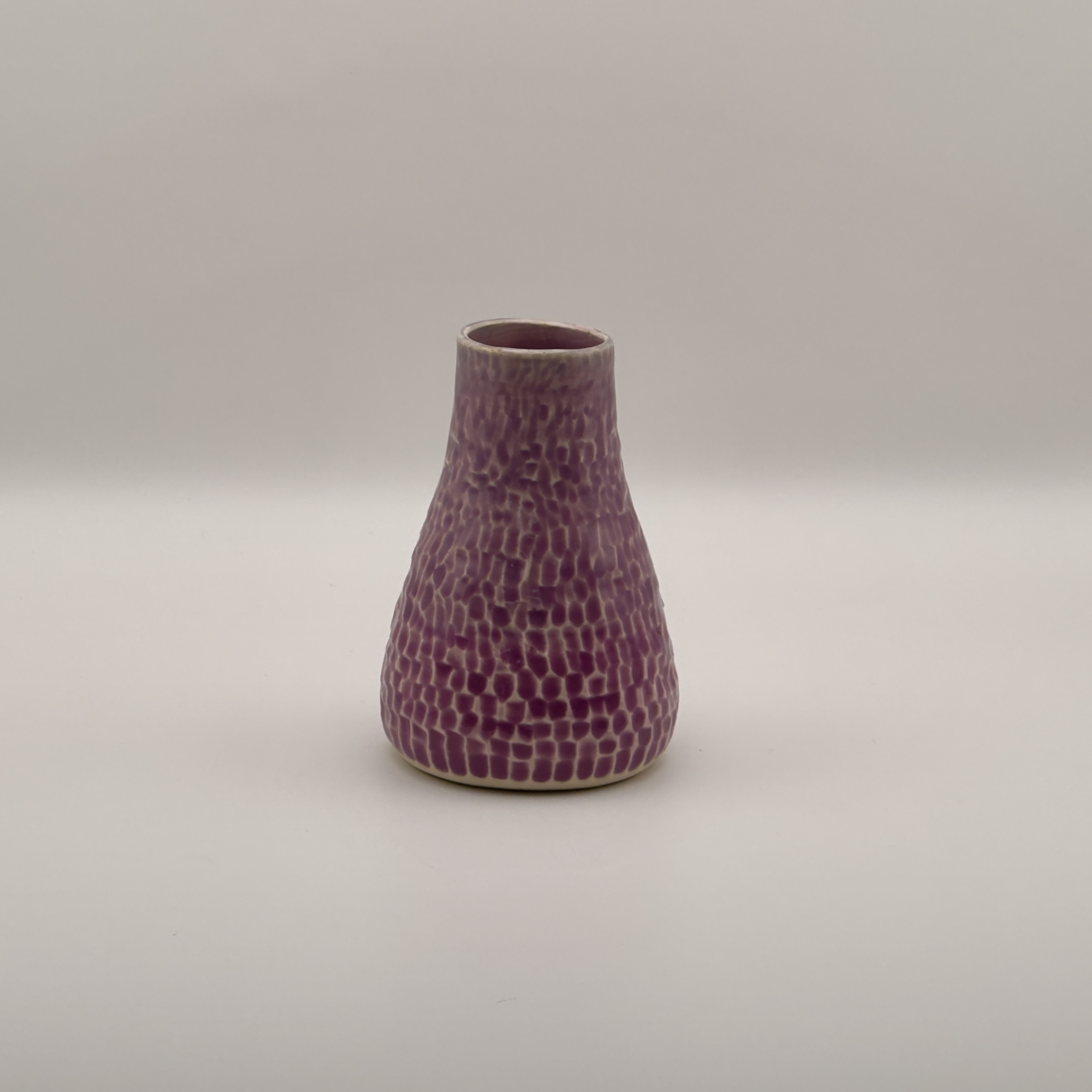 Mauve bud vase with a dimpled texture