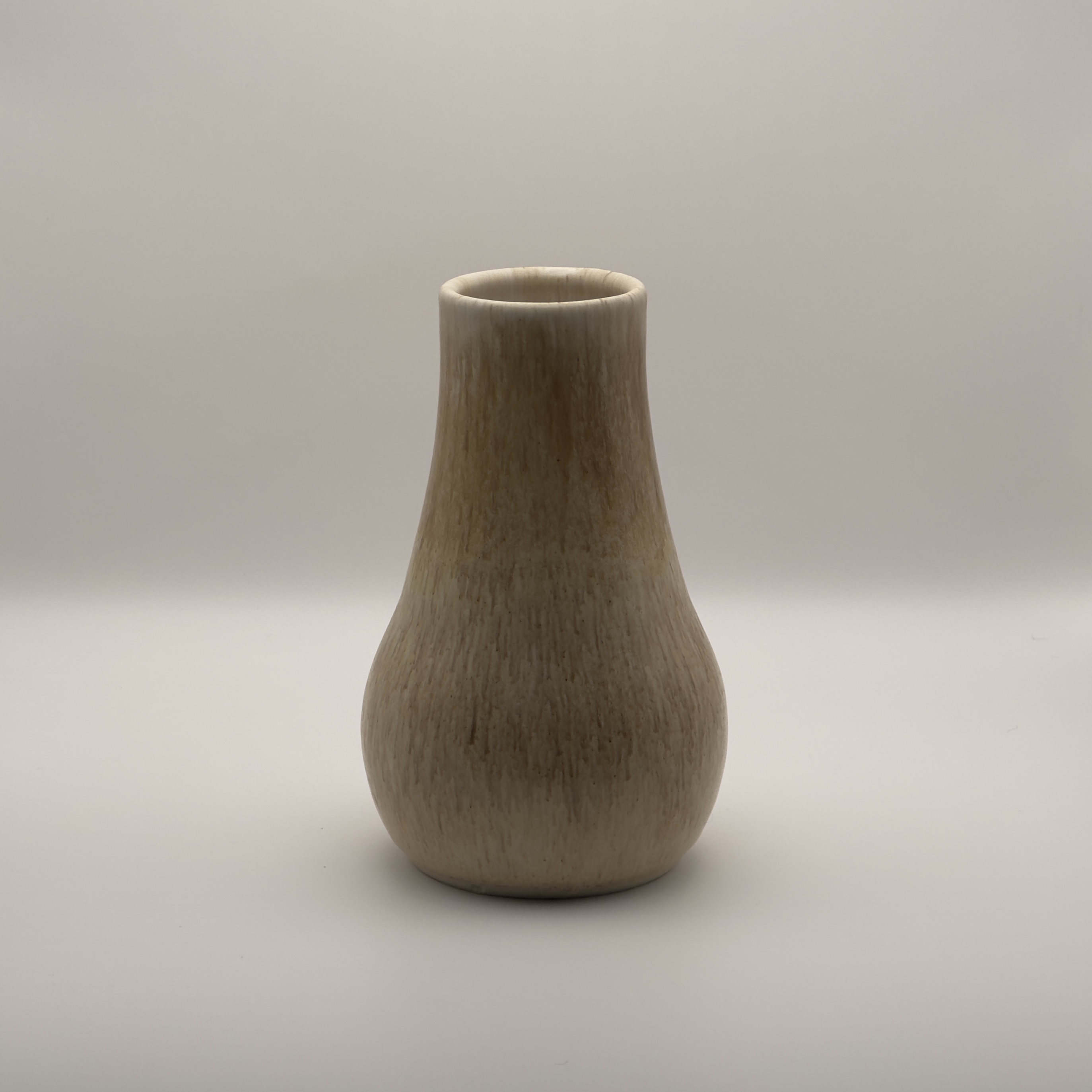 Cream bud vase with vertical ribbing and a narrow neck