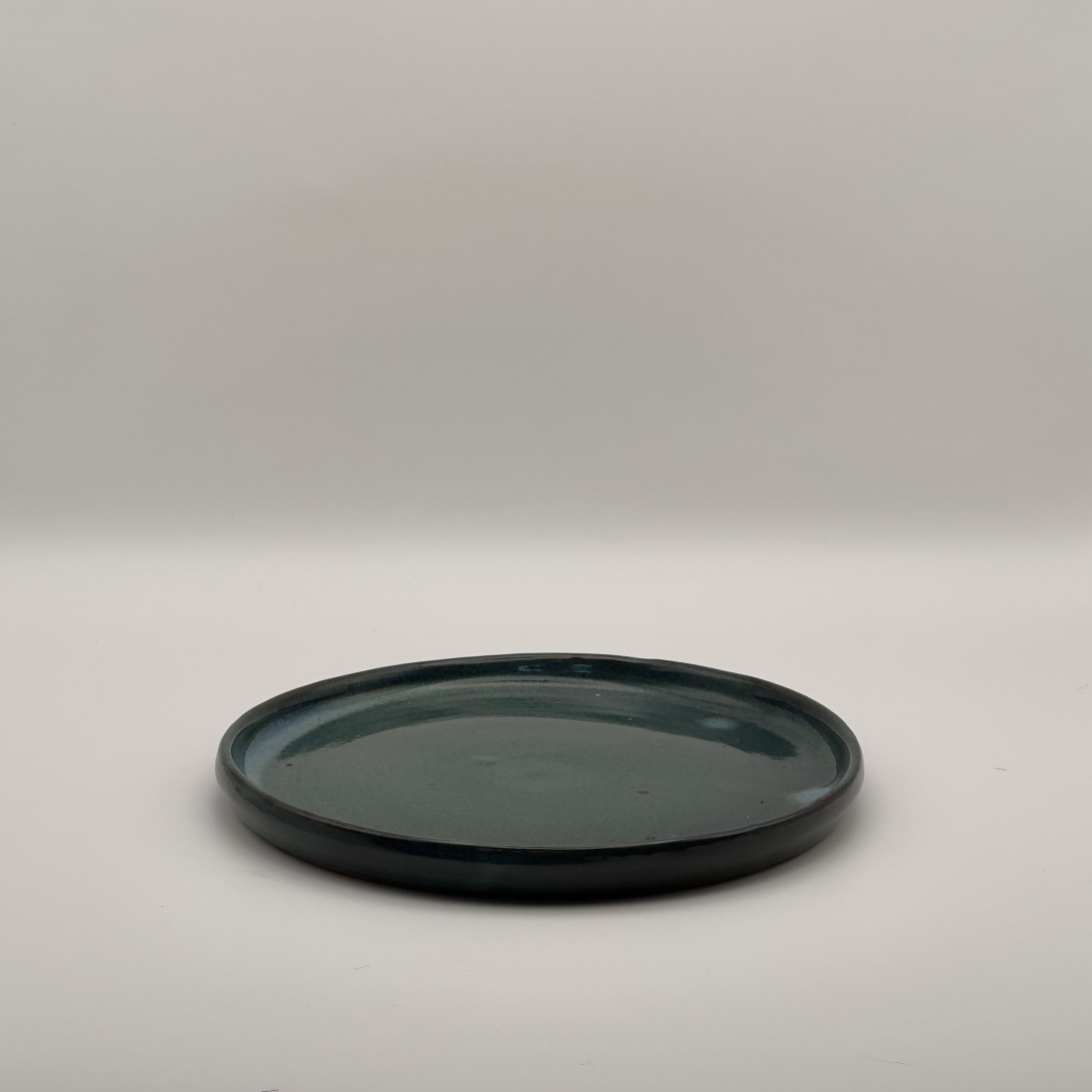 Flat teal blue glazed plate